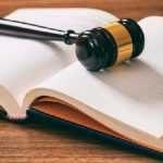 judge-or-auction-gavel-on-an-open-book-wooden-P88GACA-min-e1518780083733