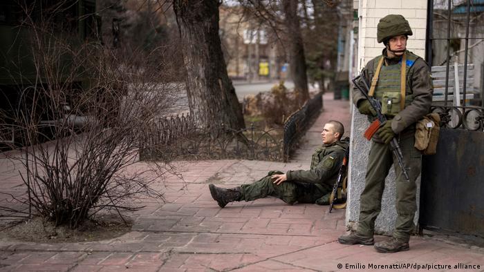 Поранений військовослужбовець української армії сидить на вулиці Києва 24 лютого 2022 року