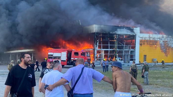 Очевидці спостерігають за пожежею в ТЦ Амстор у Кременчуці, зруйнованій внаслідок ракетного влучення