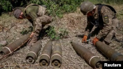 Украинские военнослужащие готовят снаряды для стрельбы из гаубицы M777 вблизи линии фронта Донецкой области, 6 июня 2022 года