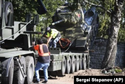 Во время демонтажа советского танка Т-34, установленного как памятник, посвящен Второй мировой войне.  Нарва, Эстония, 16 августа 2022 года.