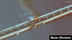 На цветном инфракрасном спутниковом снимке крупным планом виден дым, поднимающийся от пожара на Керченском мосту в Керченском проливе, Крым, 8 октября 2022 года